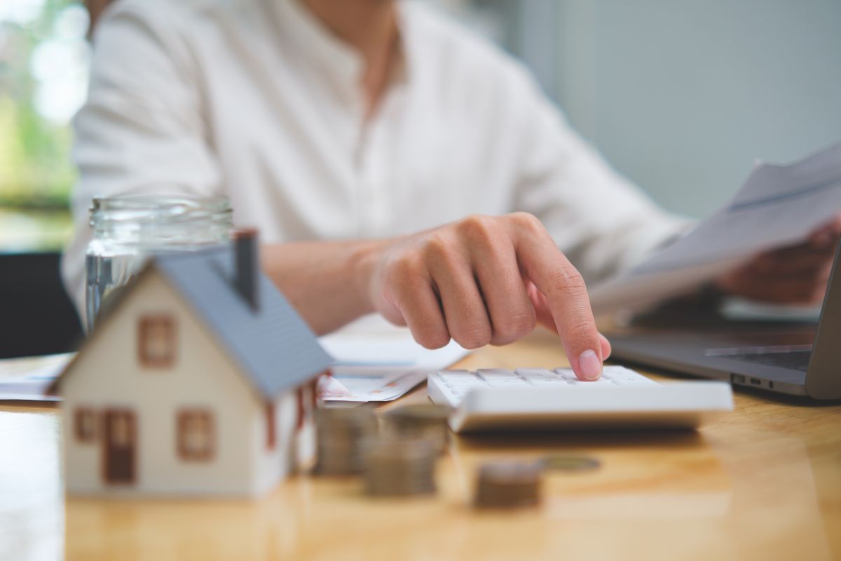 Ein Mitarbeiter der Immobilienbranche berechnet etwas auf einem Taschenrechner